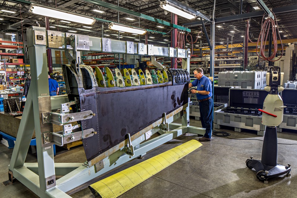 A Patriot Machine associate using a laser tracker to make precise measurements on a bulkhead.