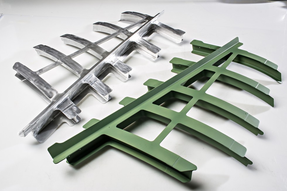 Two identical bulkheads, one painted green and one unpainted.