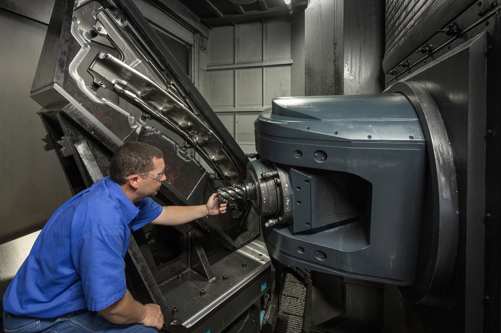 A Patriot Machine associate servicing a six-axis machining center.