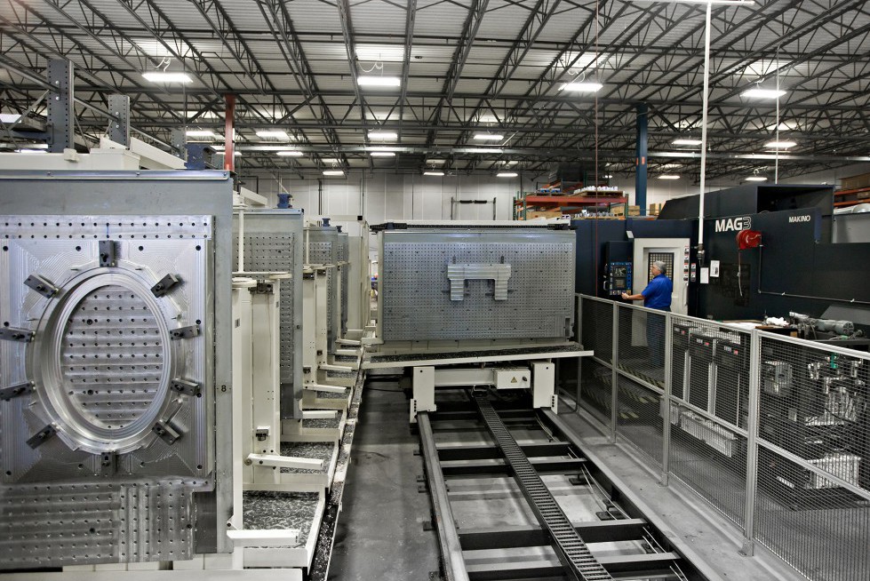 A large part being moved along a track on the shop floor.
