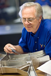 A Patriot Machine associate using a precision measurement tool called on a machined part.