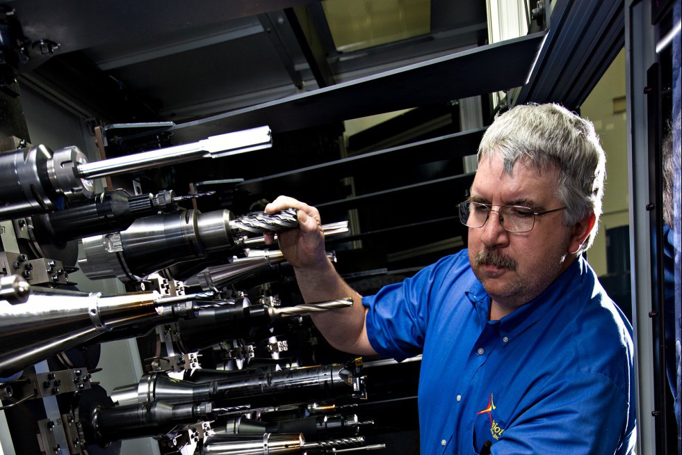 A Patriot Machine associate carefully choosing the spindles for use in a machining cell.